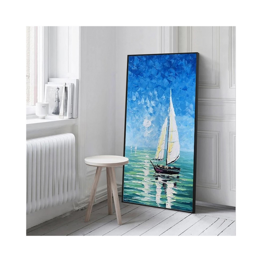 Framed painting of a sailboat on a blue sky with white clouds in a room with a radiator and small table.