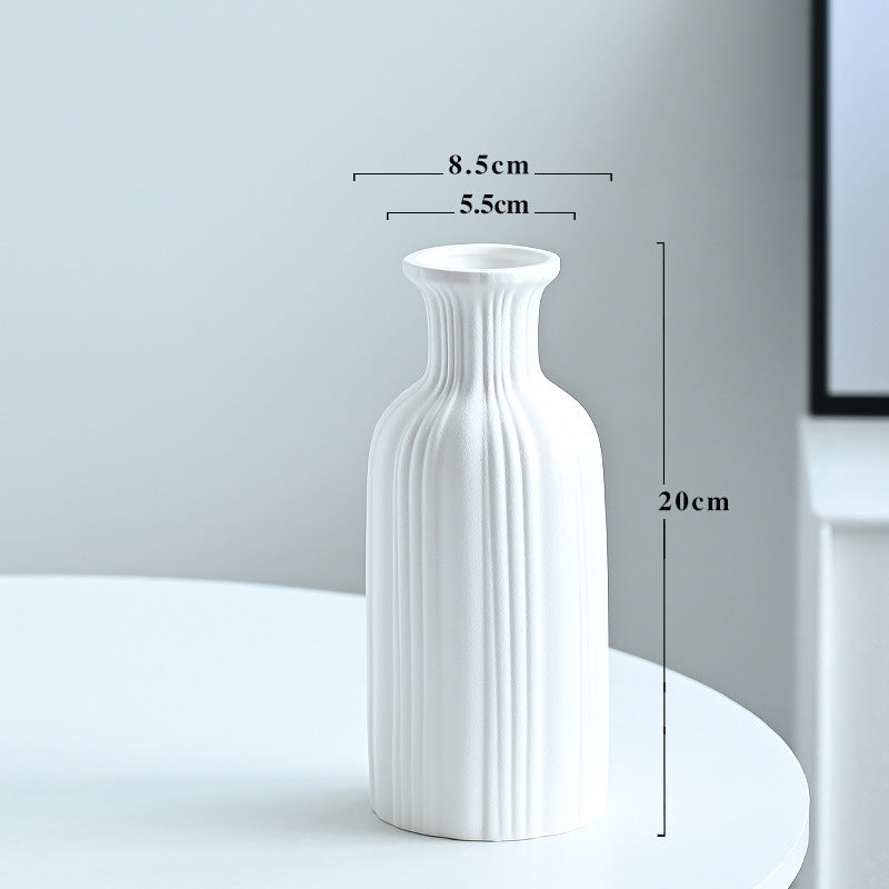 White textured vase on a white surface with dimensions indicated