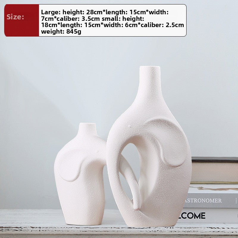 Two white ceramic vases on a shelf with size information displayed.