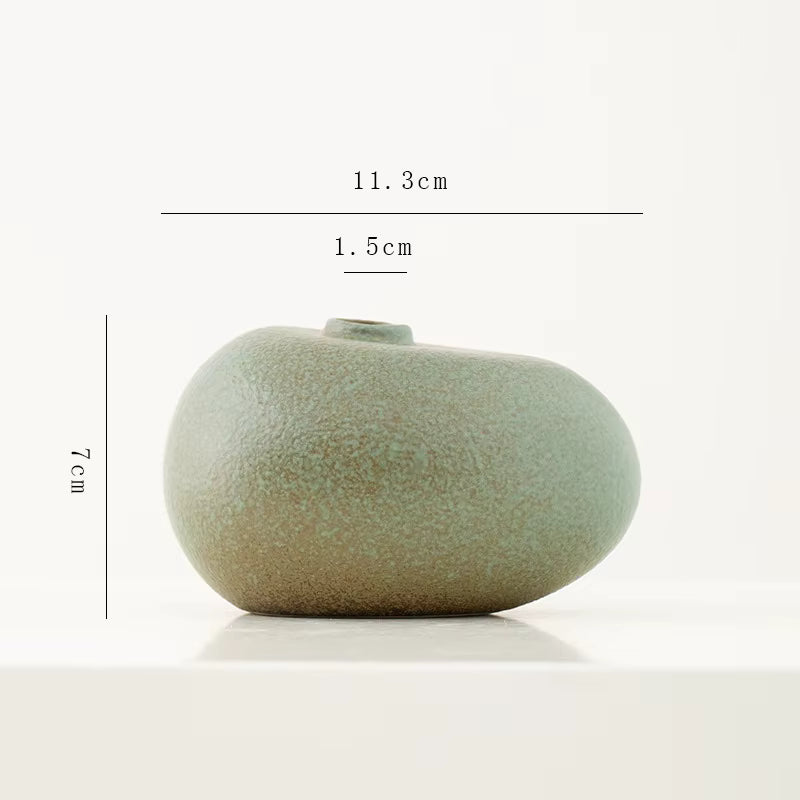 Green ceramic vase with dimensions labeled on a white background