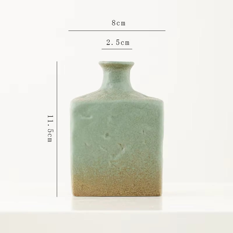 Green ceramic vase with dimensions on a white background