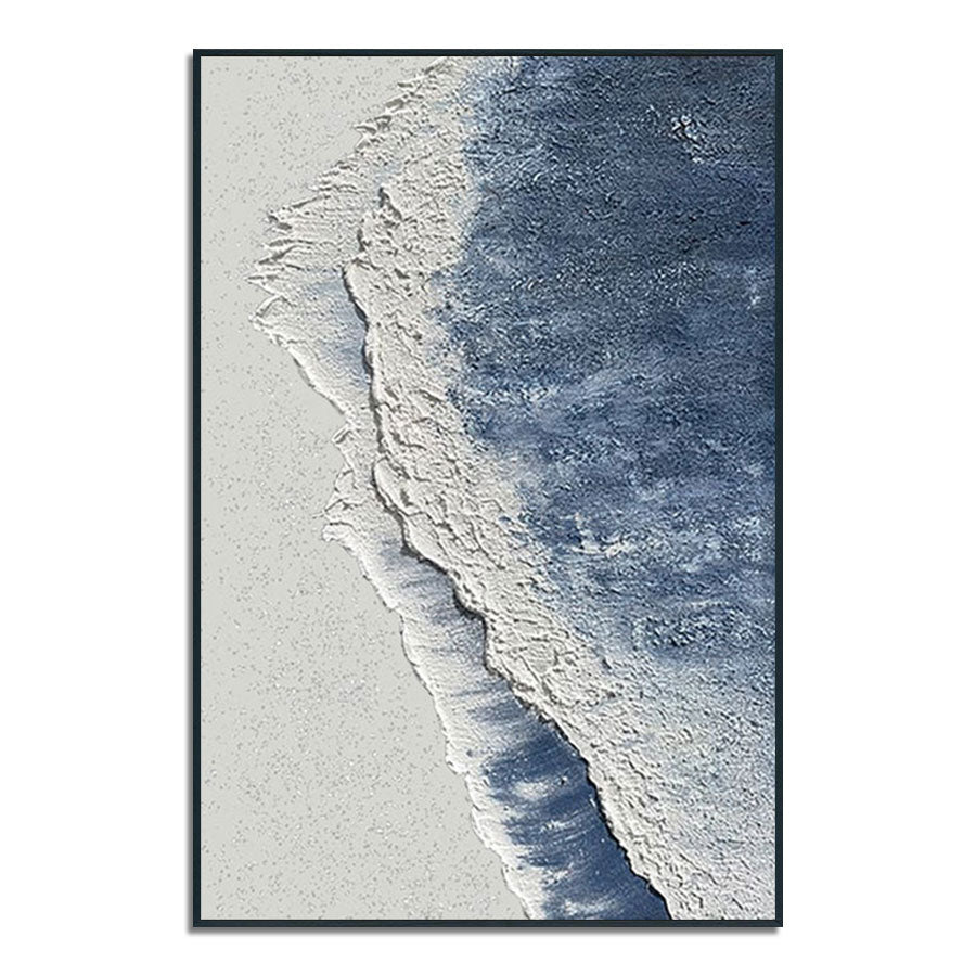 Framed artwork of a beach scene with blue water and white sand.