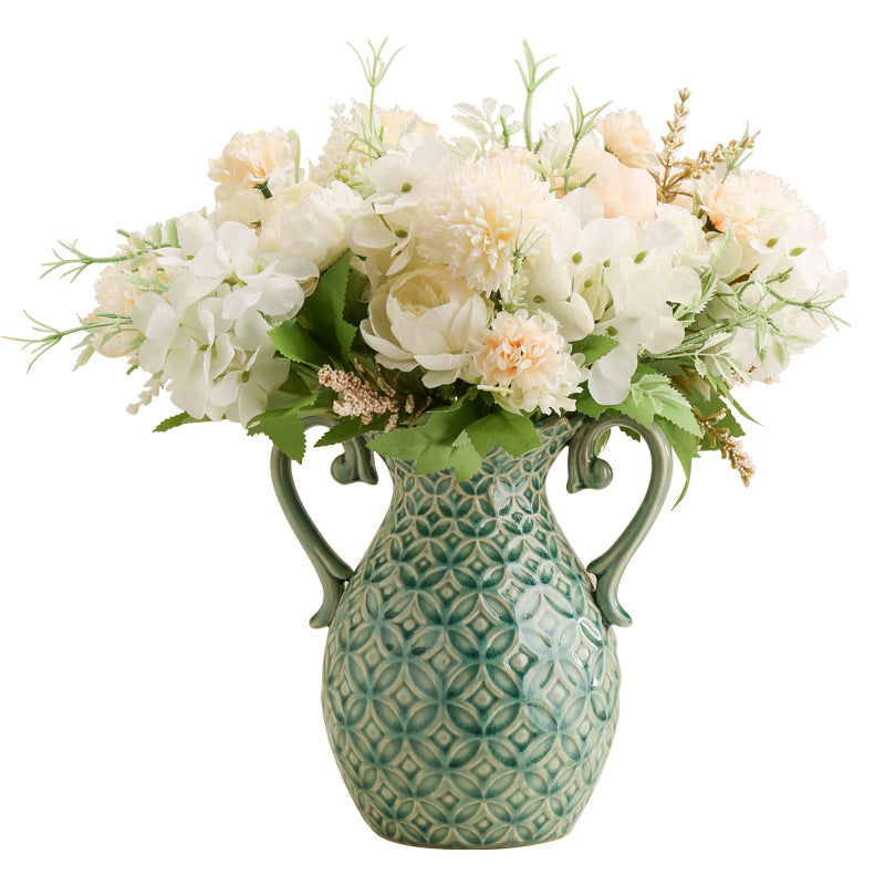 Decorative vase with floral arrangement on a white background