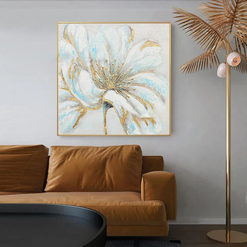 Abstract floral painting on a wall above a brown sofa with a gold-framed artwork.