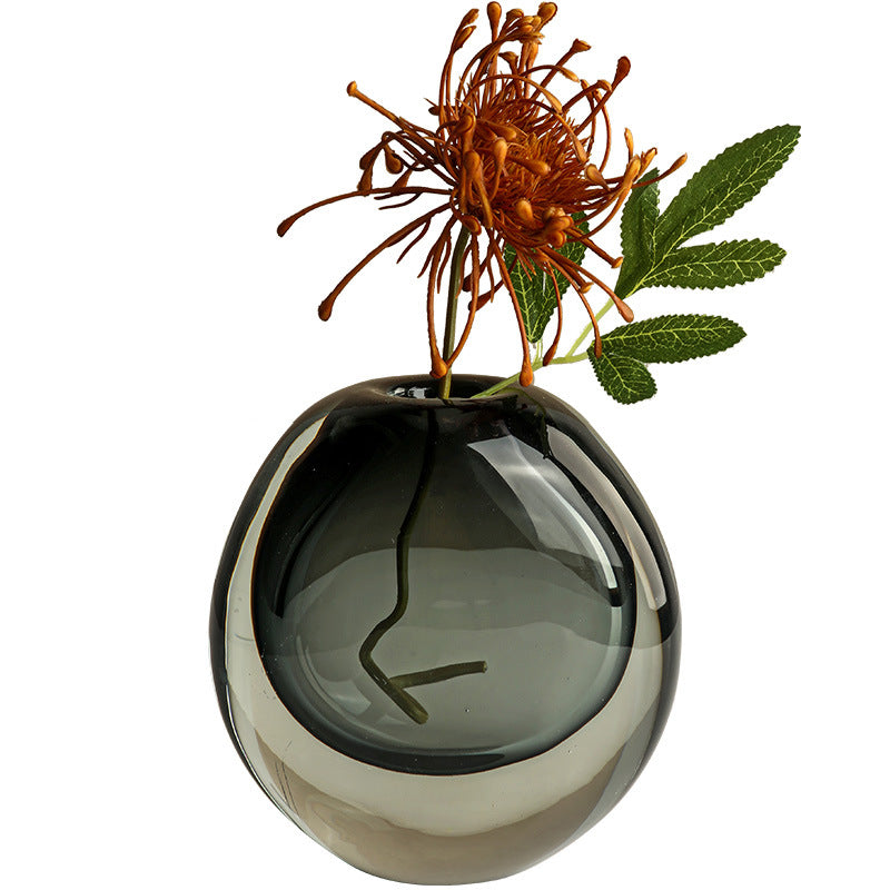 Smoky gray vase with a single flower on a white background