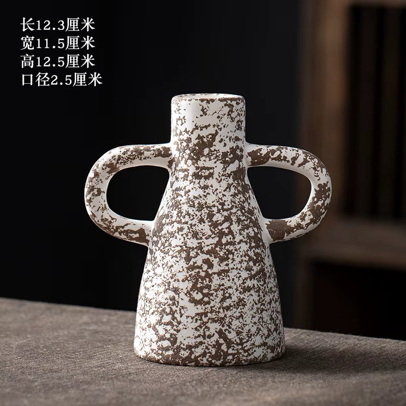 Ceramic vase with handles on a dark background