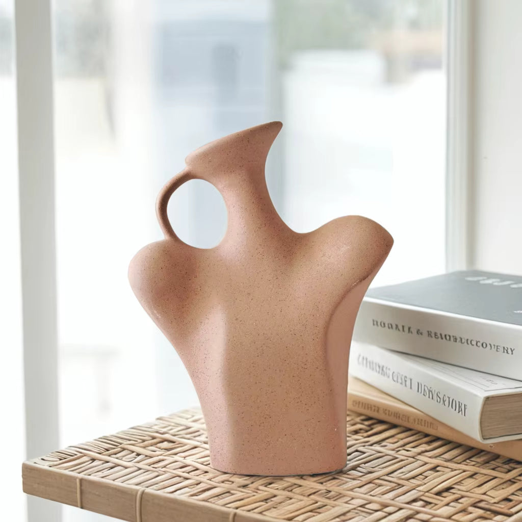 Ceramic vase on a woven surface with books in the background