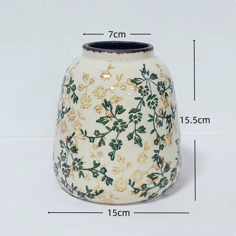 Ceramic vase with floral patterns and measurements on a white background