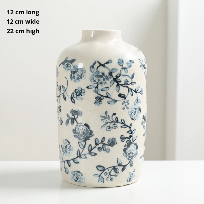 White vase with blue floral pattern on a white background