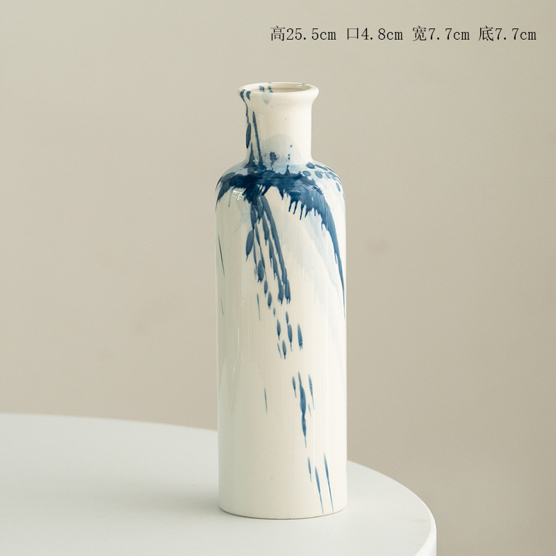 White vase with blue abstract patterns on a beige background