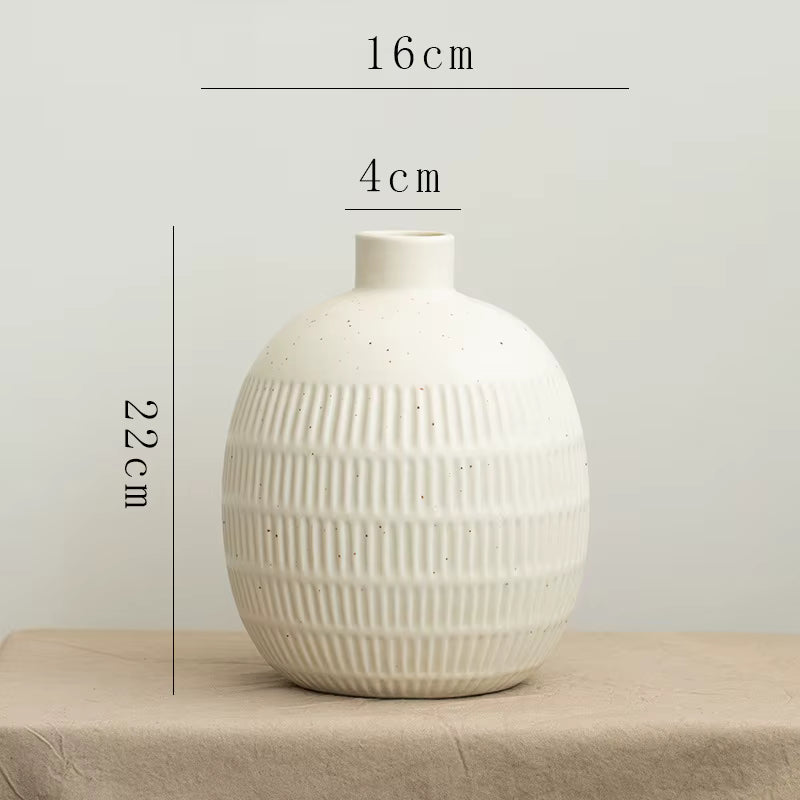 White textured vase with measurements on a neutral background
