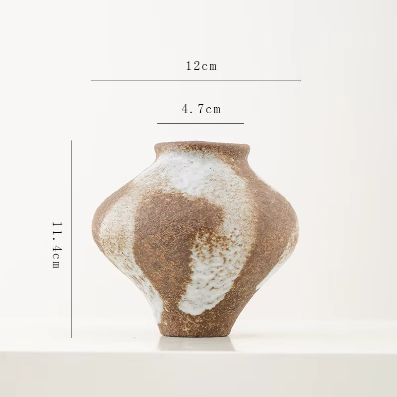 Ceramic vase with measurement labels on a white background