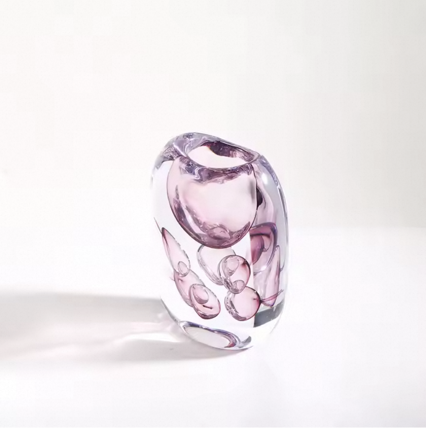 Pink glass vase on a white background