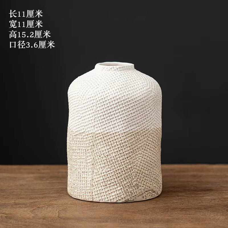 Textured ceramic vase on a wooden surface with a dark background