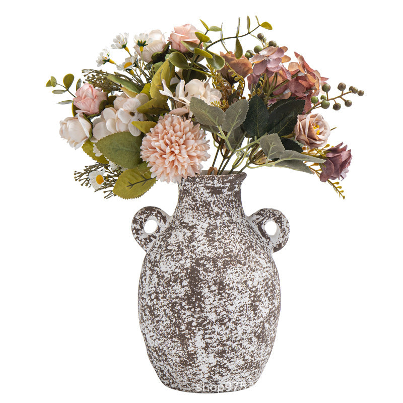 Decorative vase with floral arrangement on a white background