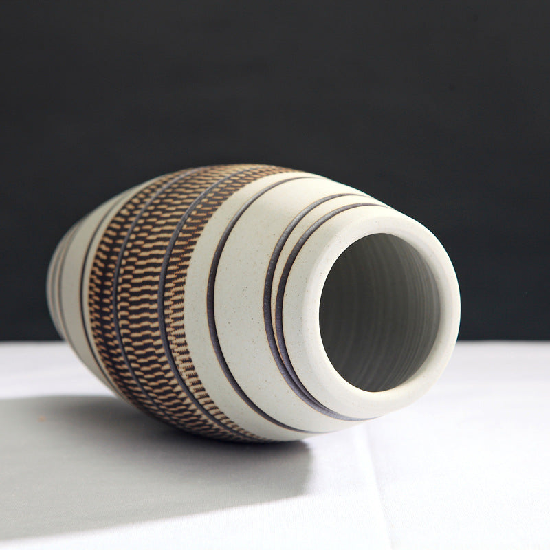 Ceramic vase with textured design on a black background