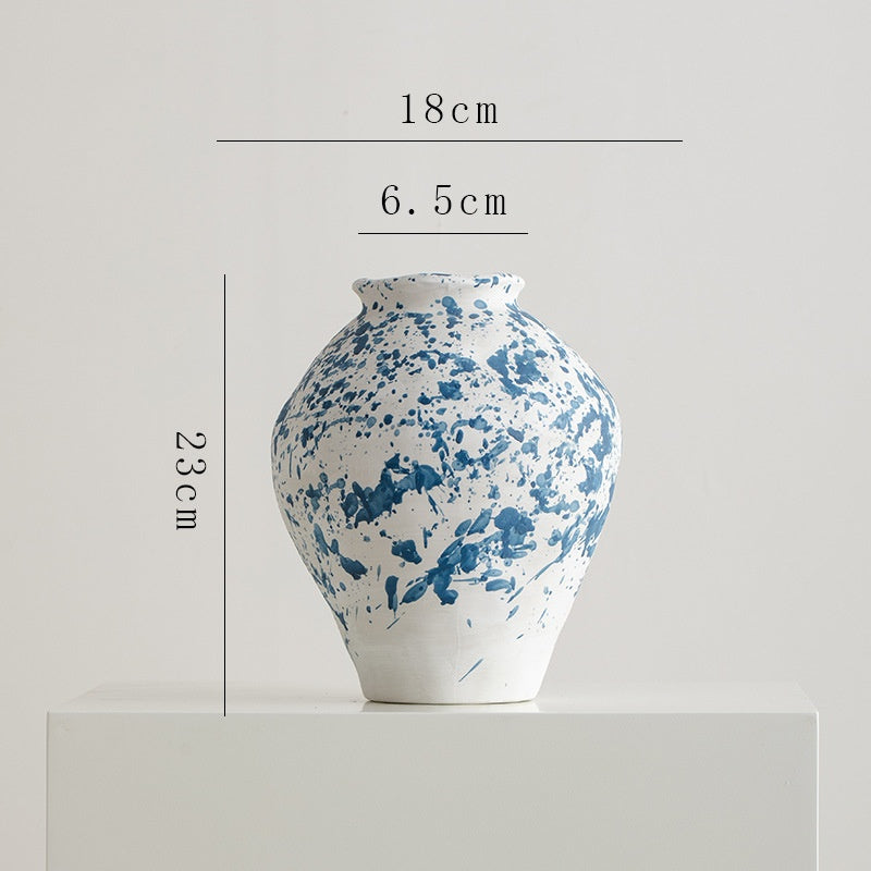 Blue and white ceramic vase with dimensions on a light gray background