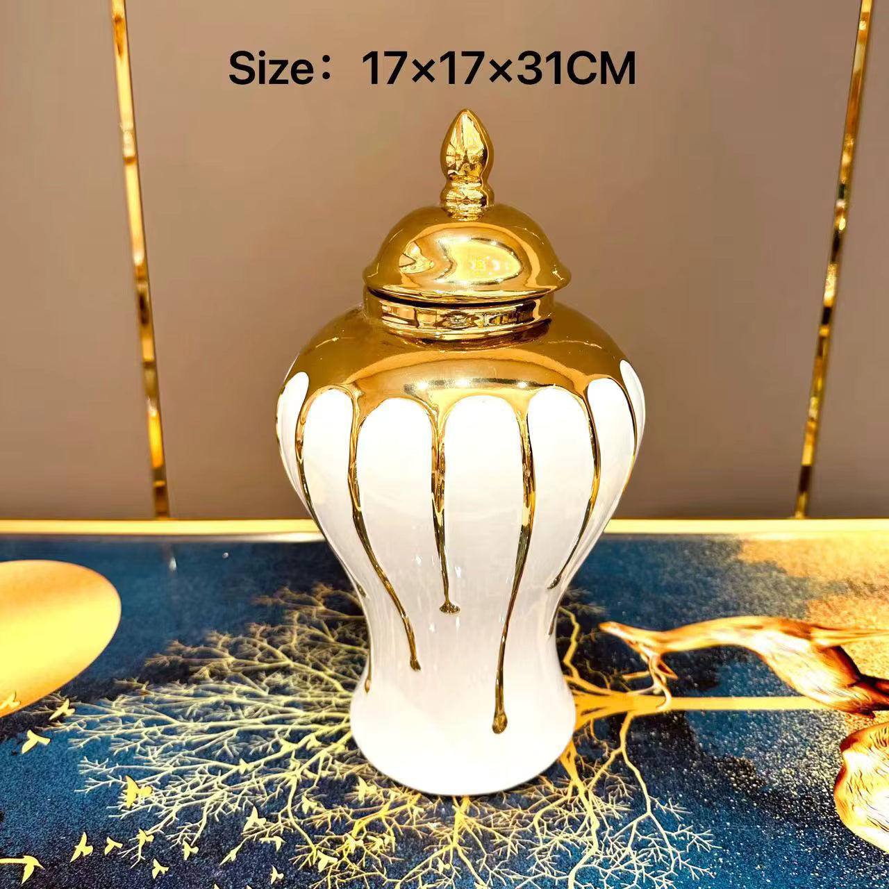 Decorative white vase with gold accents on a reflective surface
