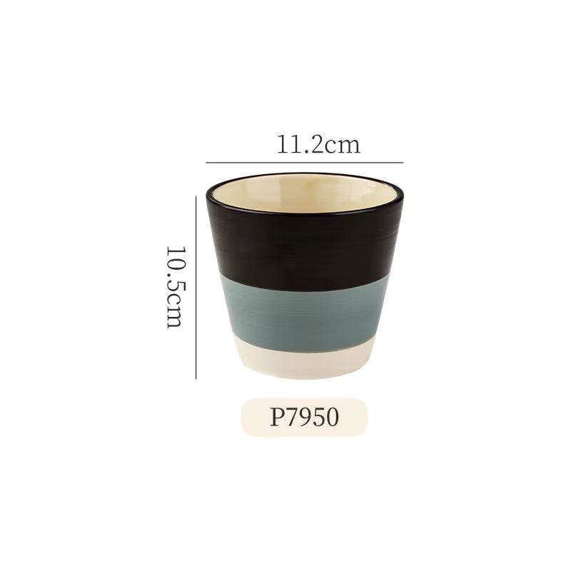 Two-tone ceramic cup with measurements on a white background