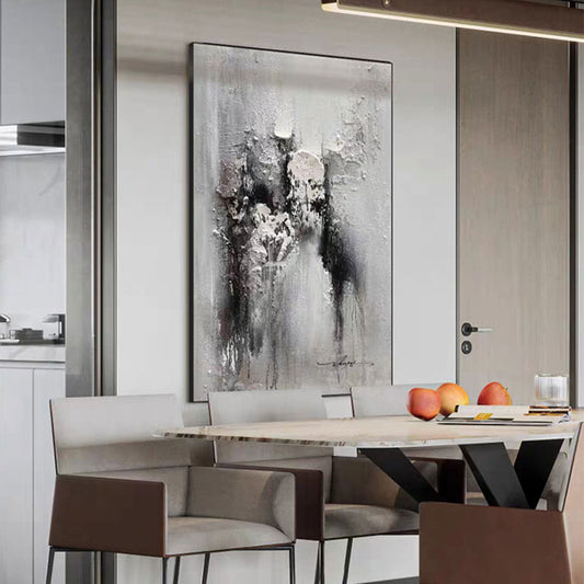 Dining room with abstract art on the wall, table with fruit, and chairs.