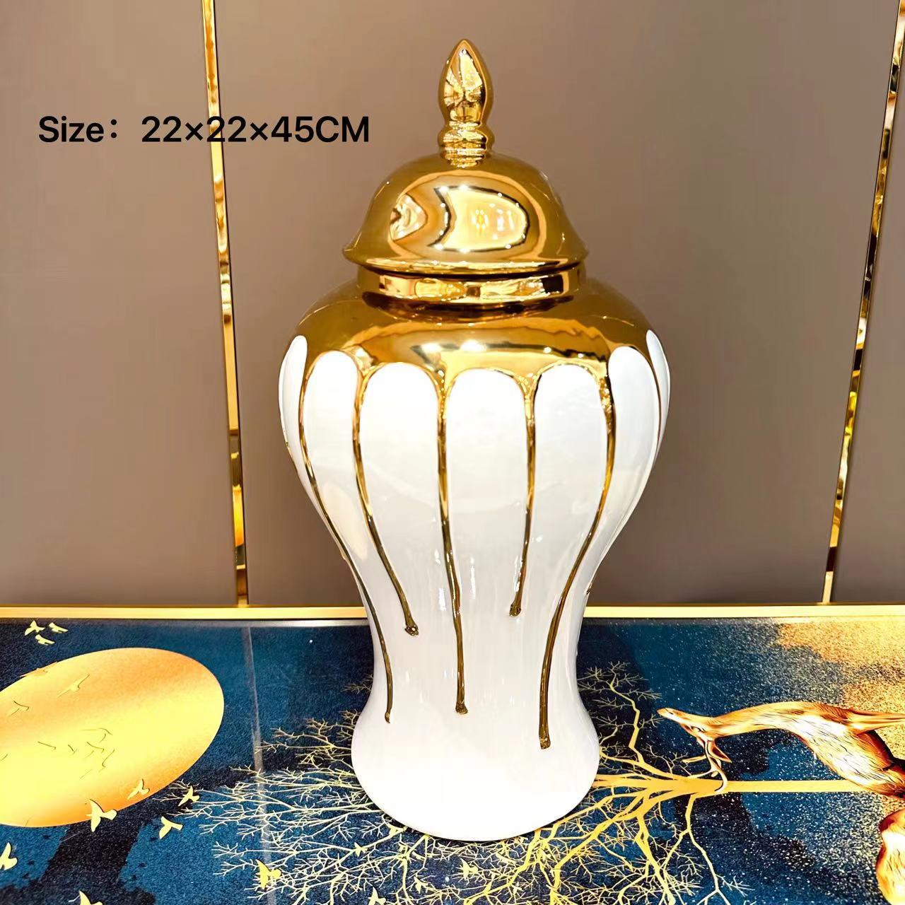 Decorative white vase with gold accents on a decorative surface
