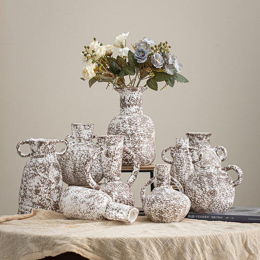Collection of decorative vases with a textured finish on a wooden surface.