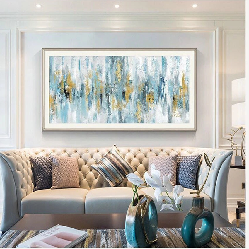 Living room with a beige sofa, abstract painting, and decorative items.