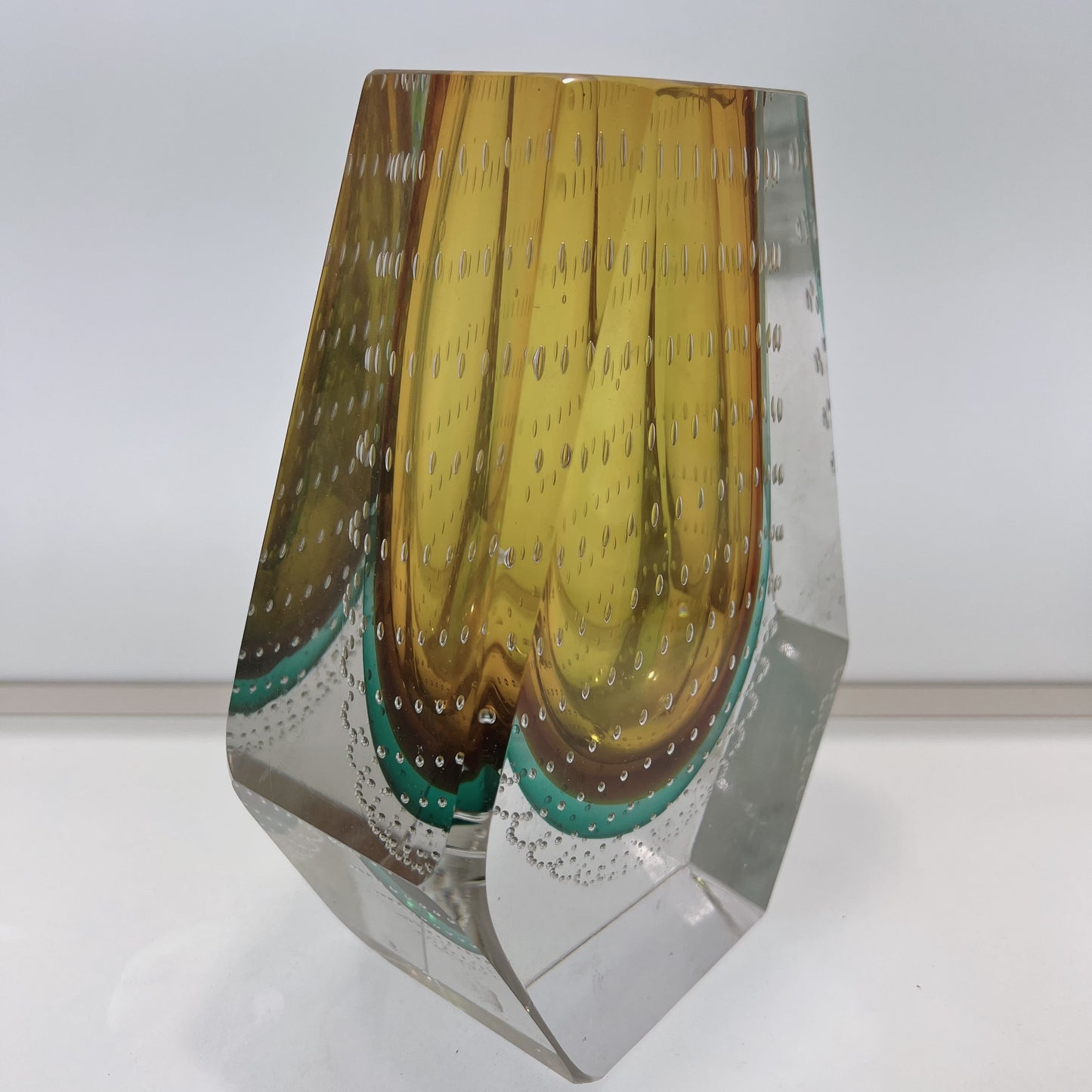 Glass vase with multicolored pattern on a white background