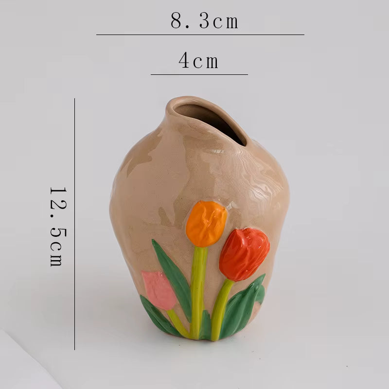 Small ceramic vase with floral design and measurements on a white background