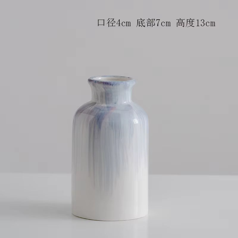 White vase with blue gradient on a light gray background