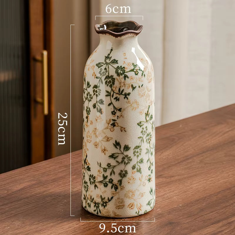 Ceramic vase with floral design on a wooden surface, showing measurements.