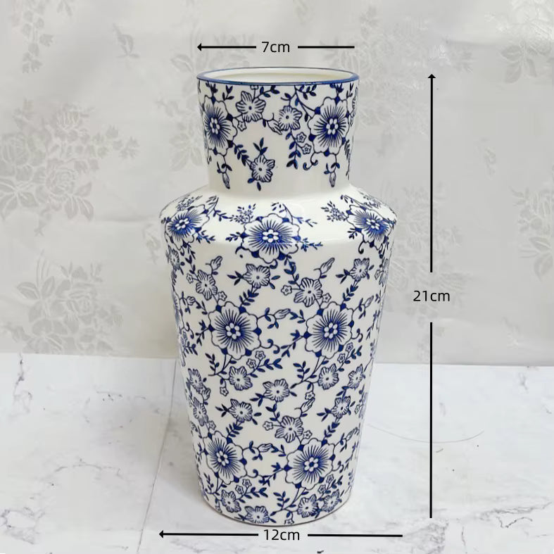 Ceramic vase with blue floral patterns and measurements on a white background