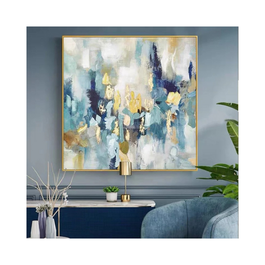 Abstract art painting in a gold frame on a wall with decorative elements below.