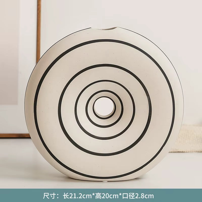 Round decorative item with concentric circles on a light background