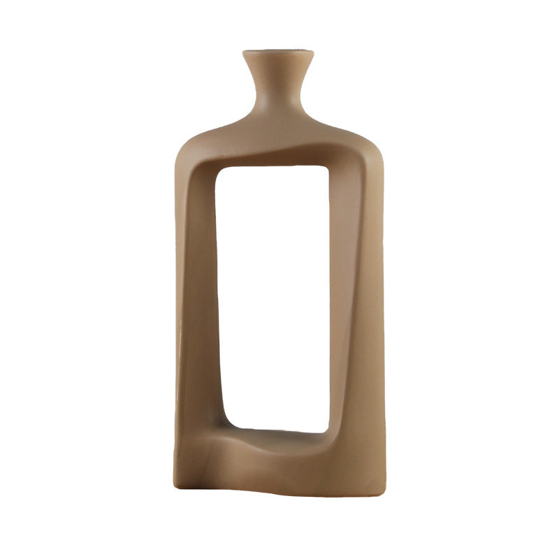 Brown ceramic vase with a rectangular opening on a white background