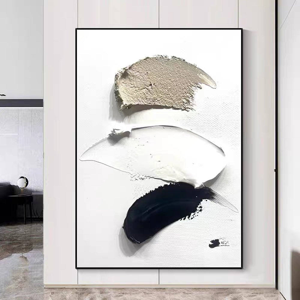 Abstract art piece with black, white, and gray brush strokes in a modern interior setting.