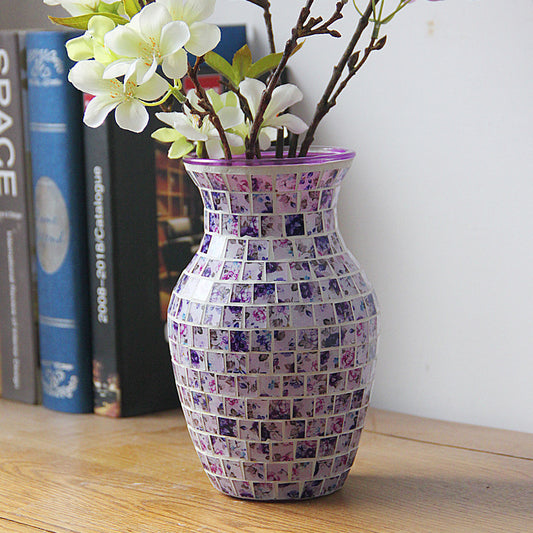Decorative mosaic vase with flowers on a wooden surface