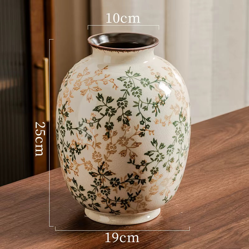 Decorative vase with floral patterns on a wooden surface, showing measurements.
