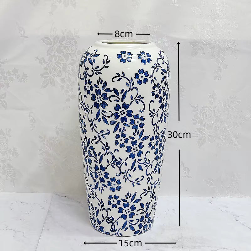 Ceramic vase with blue floral patterns and measurements on a white background
