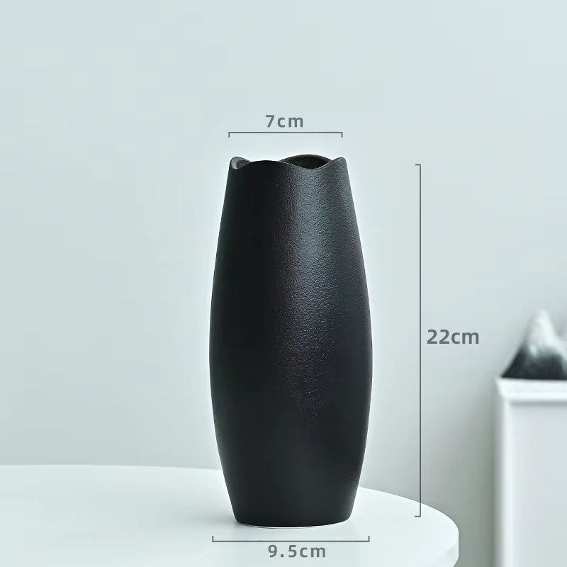 Black vase with measurements on a light gray background