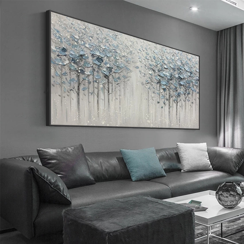 Living room with a large abstract painting on the wall above a gray sofa.