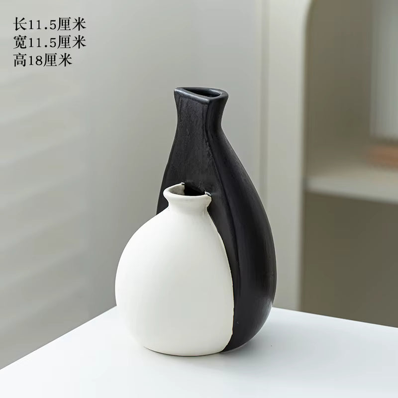 Black and white ceramic vase on a light surface with a neutral background