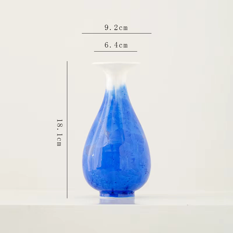 Blue glass vase with dimensions on a white background
