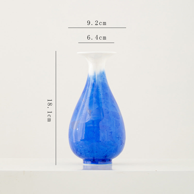 Blue glass vase with dimensions on a white background