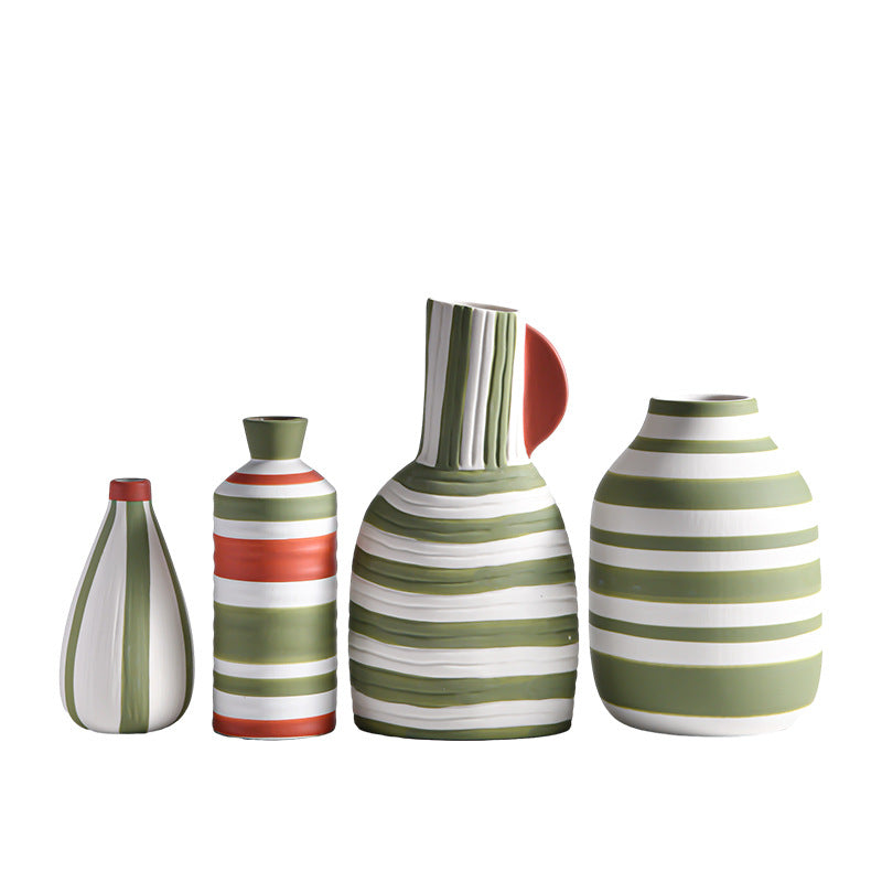 Set of four striped ceramic vases on a white background