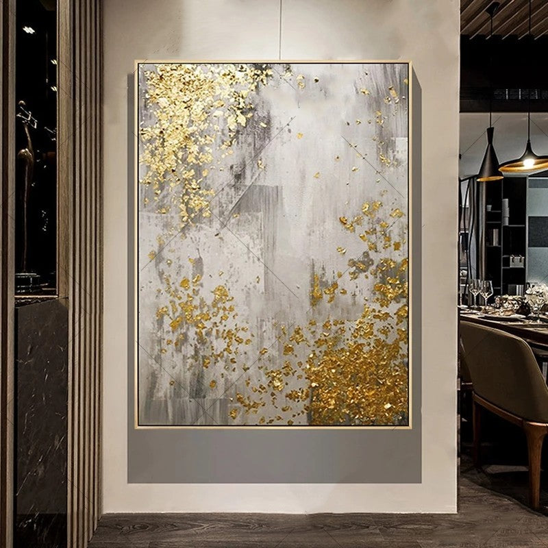 Abstract art piece with gold and gray colors in a modern interior setting.