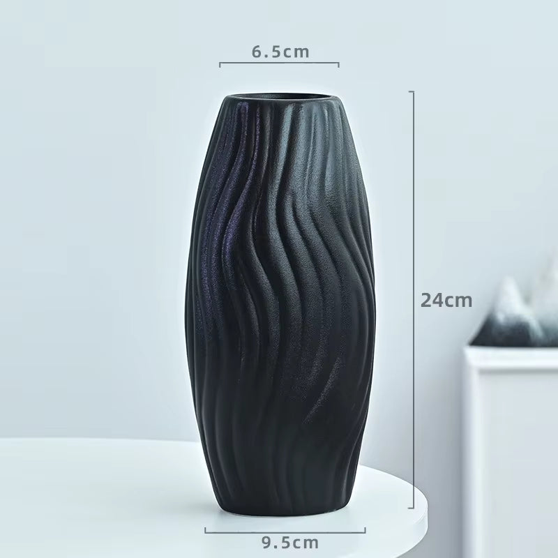 Black textured vase with dimensions on a light gray background