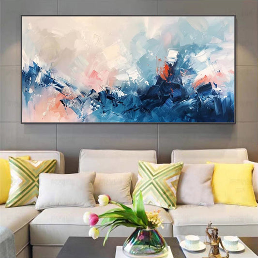 Abstract painting on a wall above a sofa with colorful cushions.