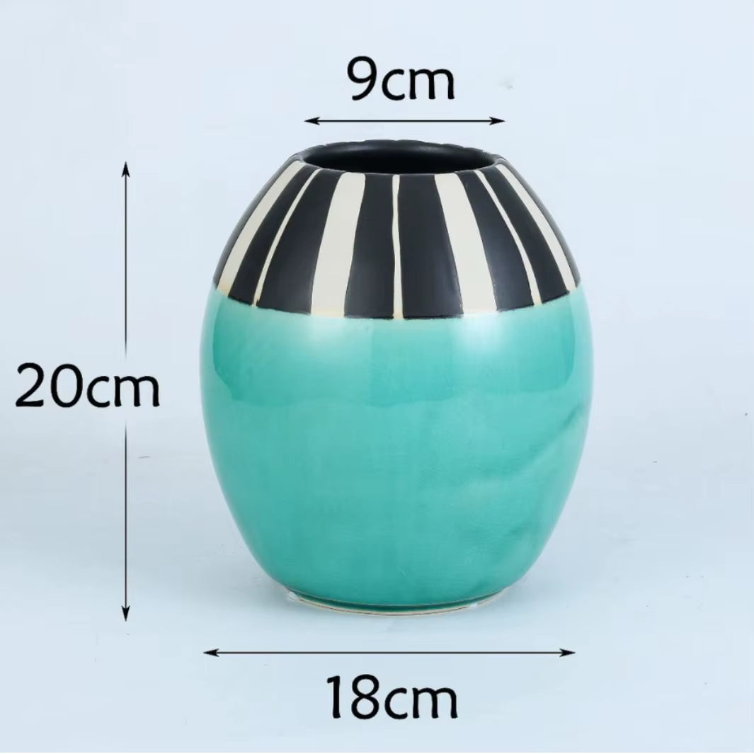 Turquoise vase with black and white striped top, measurements indicated on a light blue background