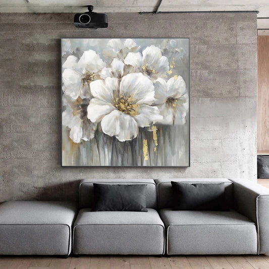 Gray wall with a large abstract floral painting above a gray sofa.